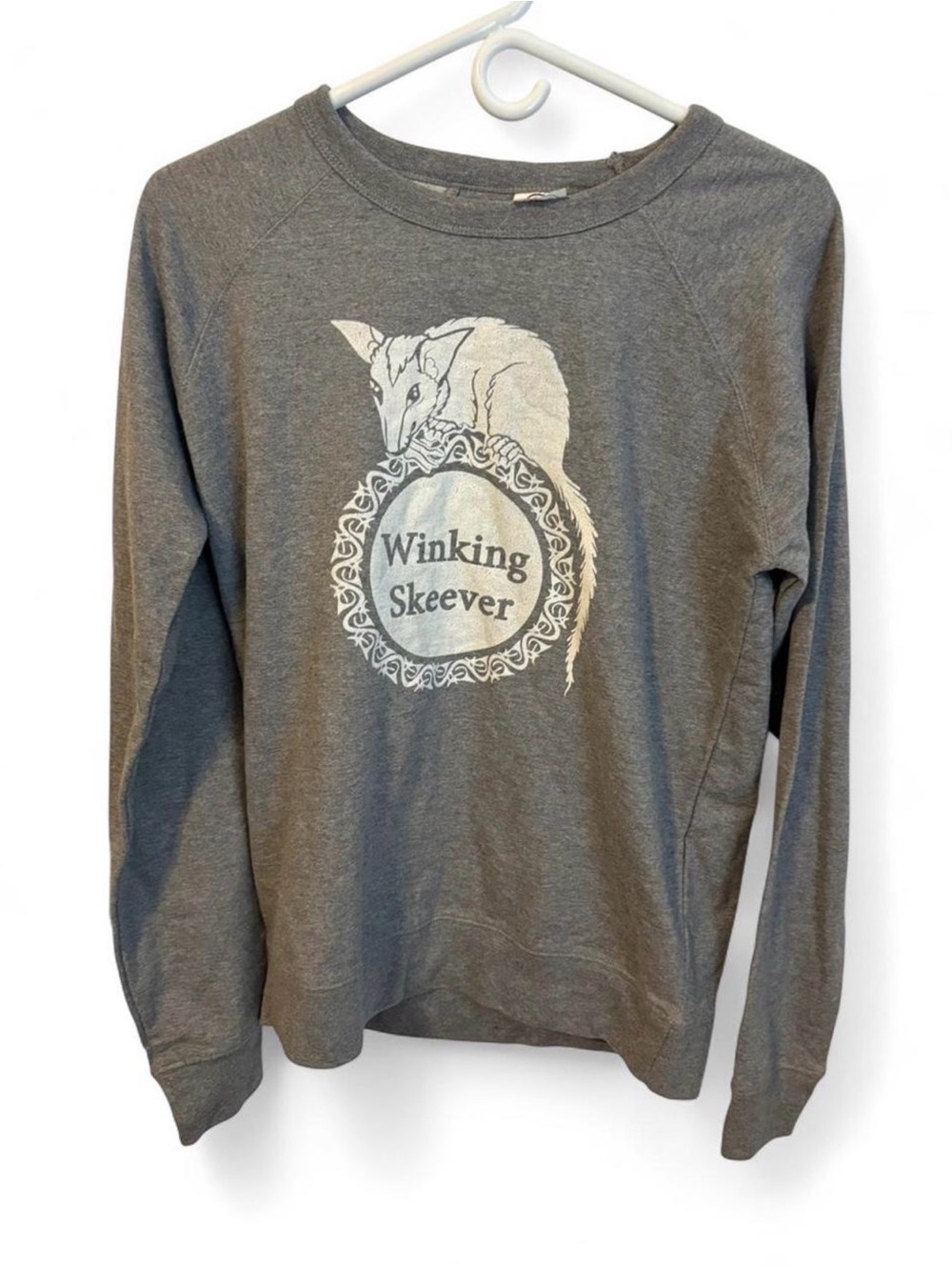 Delta Gray Crewneck Sweatshirt with Winking Skeever Illustration
